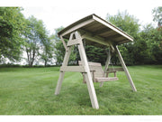 Wooden swing set with canopy in a grassy outdoor area