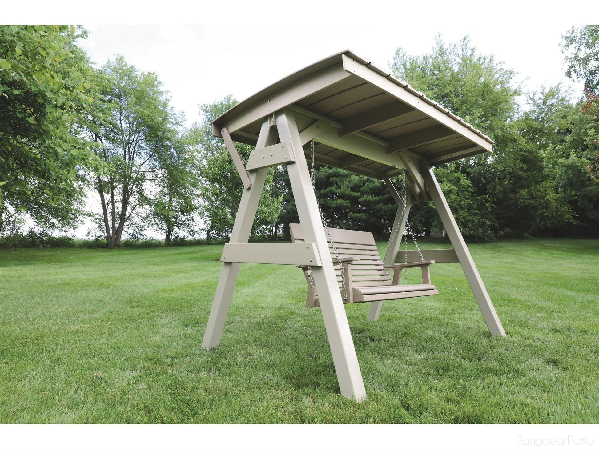 Wooden swing set with canopy in a grassy outdoor area