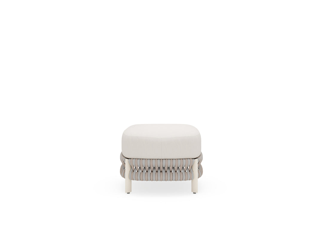 Small ottoman with a white cushion on a white background