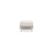 Small ottoman with a white cushion on a white background